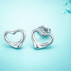 Tiffany & Co. Elsa Peretti Open Heart Stud Earrings in sterling silver.
